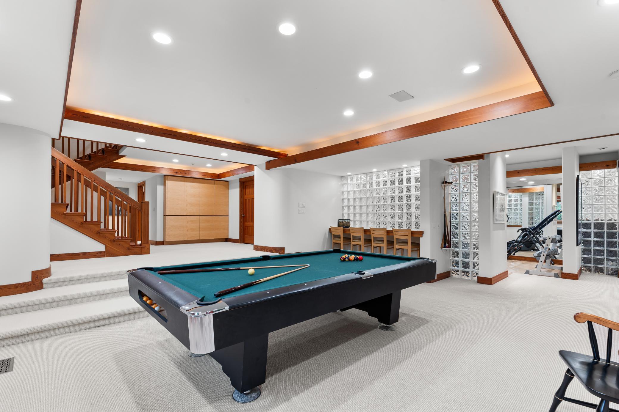 Ceiling surround lighting gives dramatic dimension to this game area
