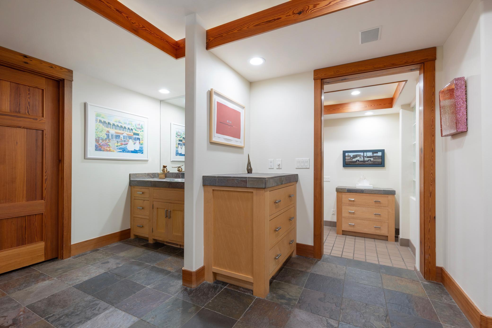 Slate floors and generous cabinetry throughout the back hallways