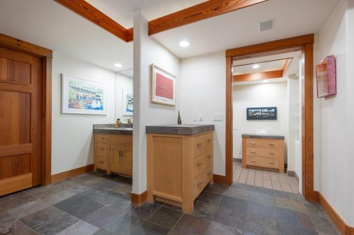 Slate floors and generous cabinetry throughout the back hallways