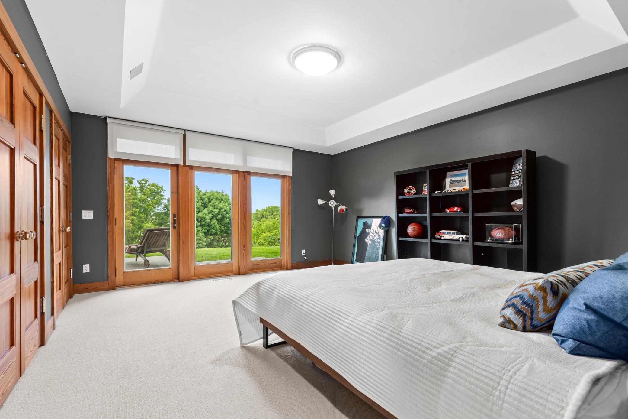 Lower level second bedroom with walk-in closets and access to the outdoor patio - western views