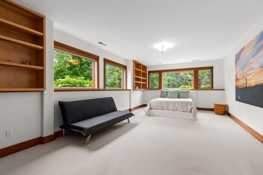 Lower level fourth bedroom with surrounding natural light and built-ins