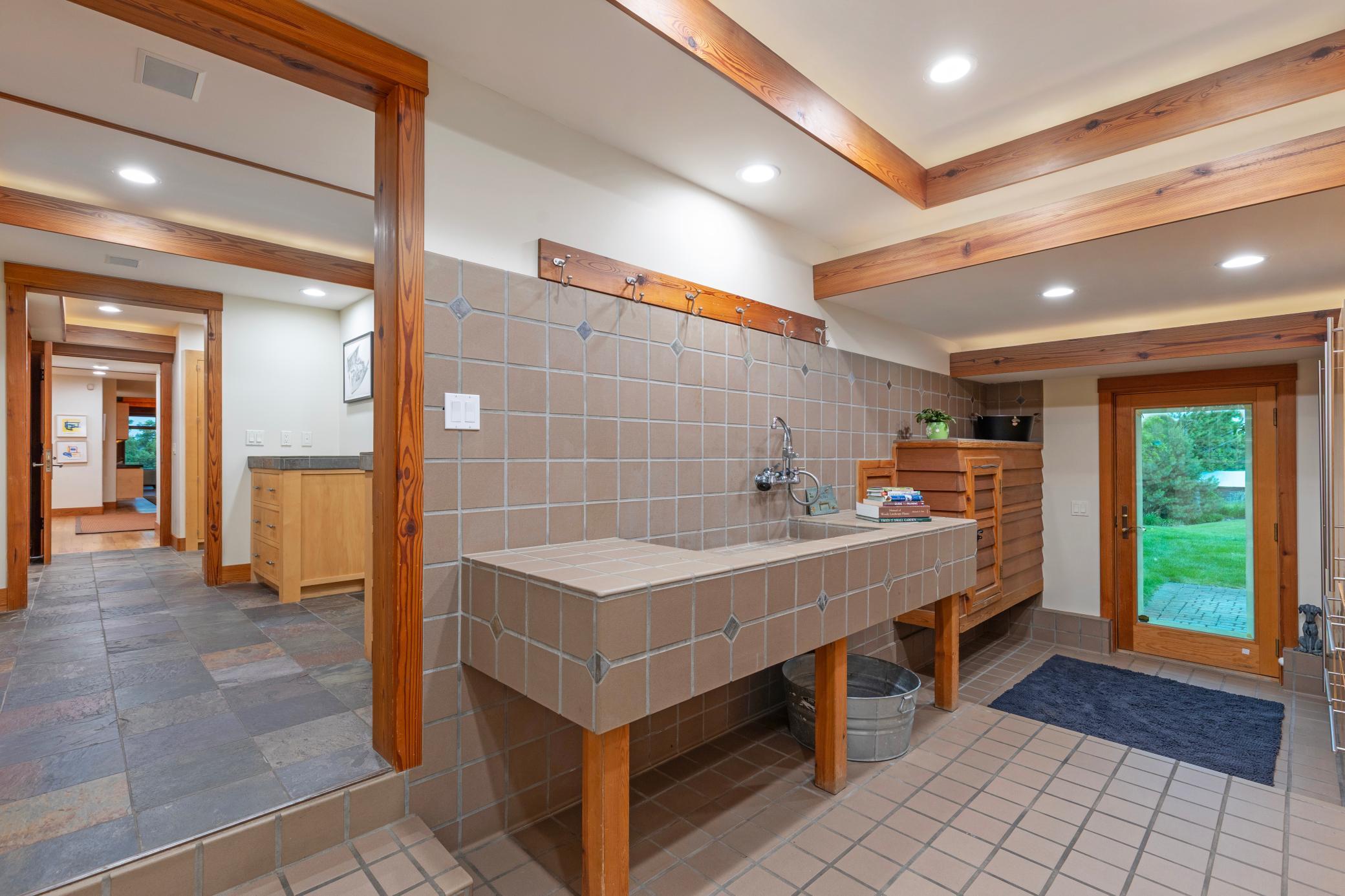 A garden room with sinks and space for transitioning from inside to the outdoors