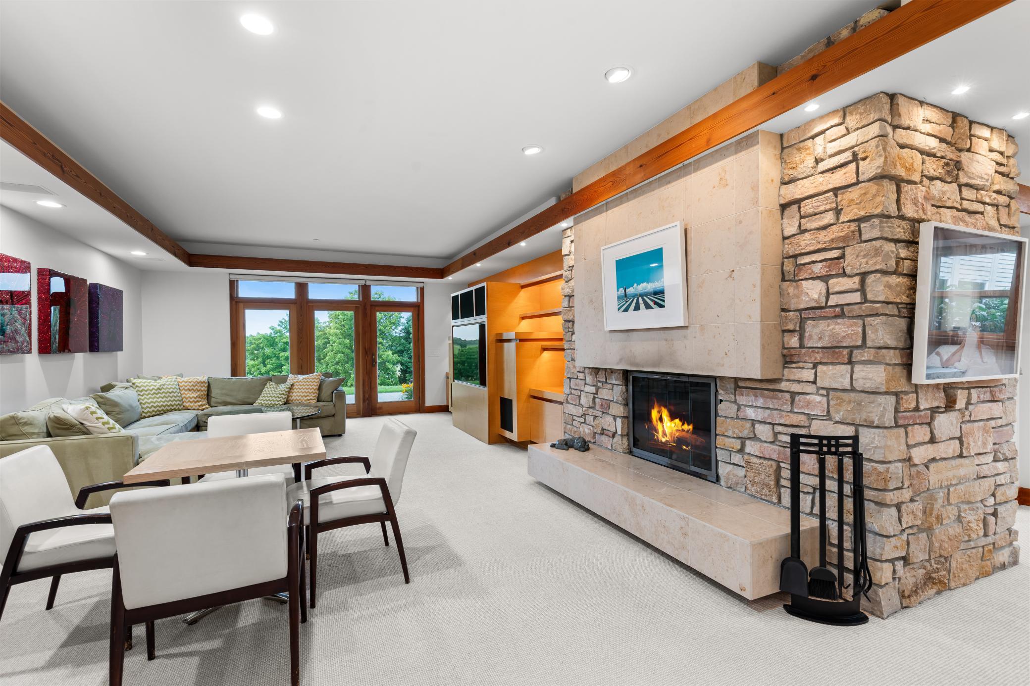 Chilton stone fireplace warms the walkout lower level family/media room