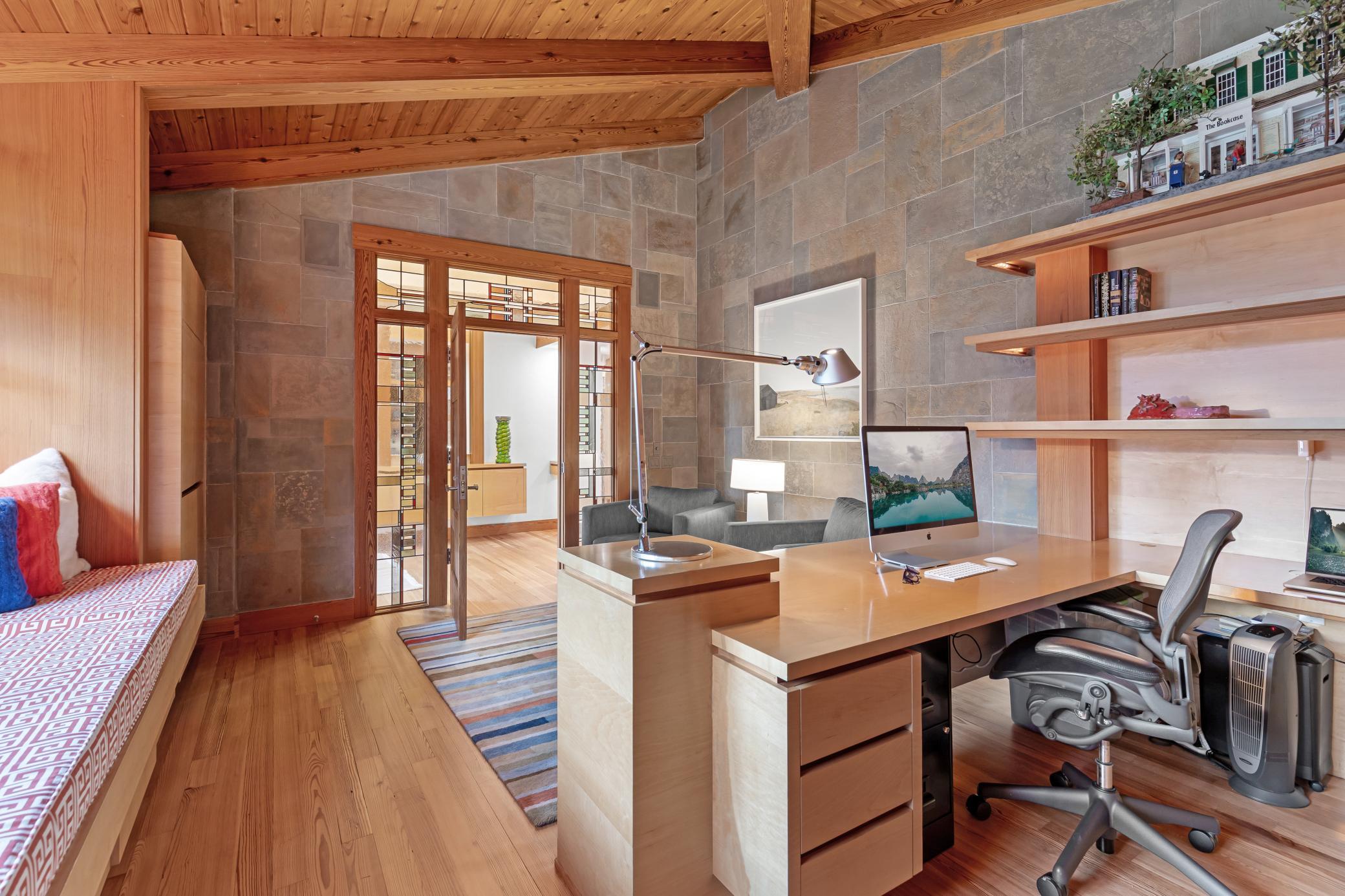 Textured walls, built-in cabinetry, and places to rest or read in the main floor office
