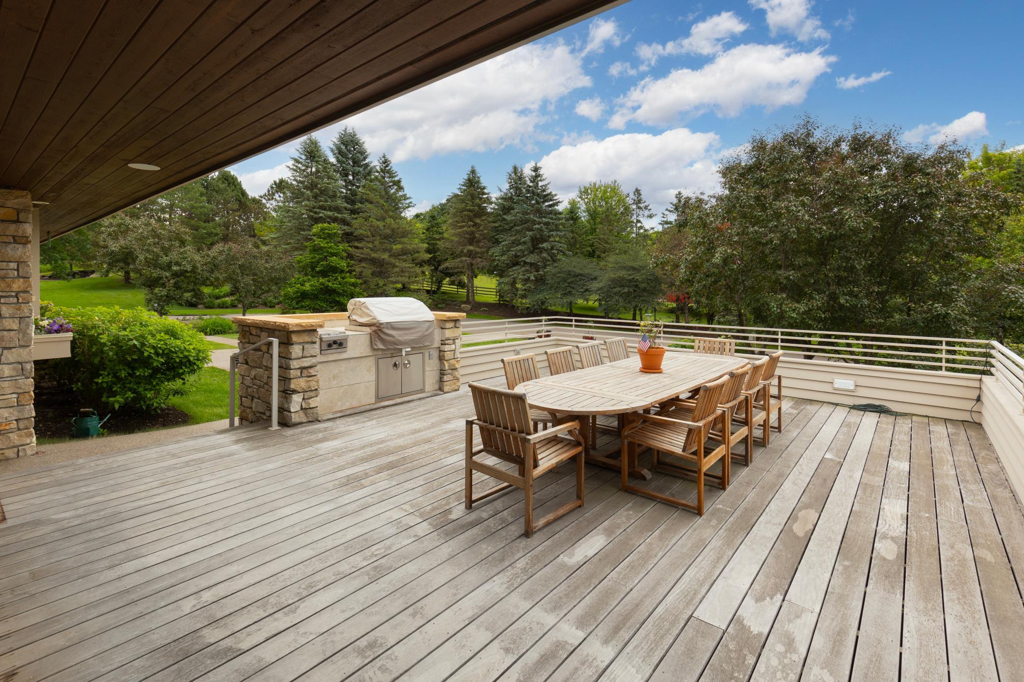 Cantilevered deck extends on the south side with grilling/kitchen for outdoor dining