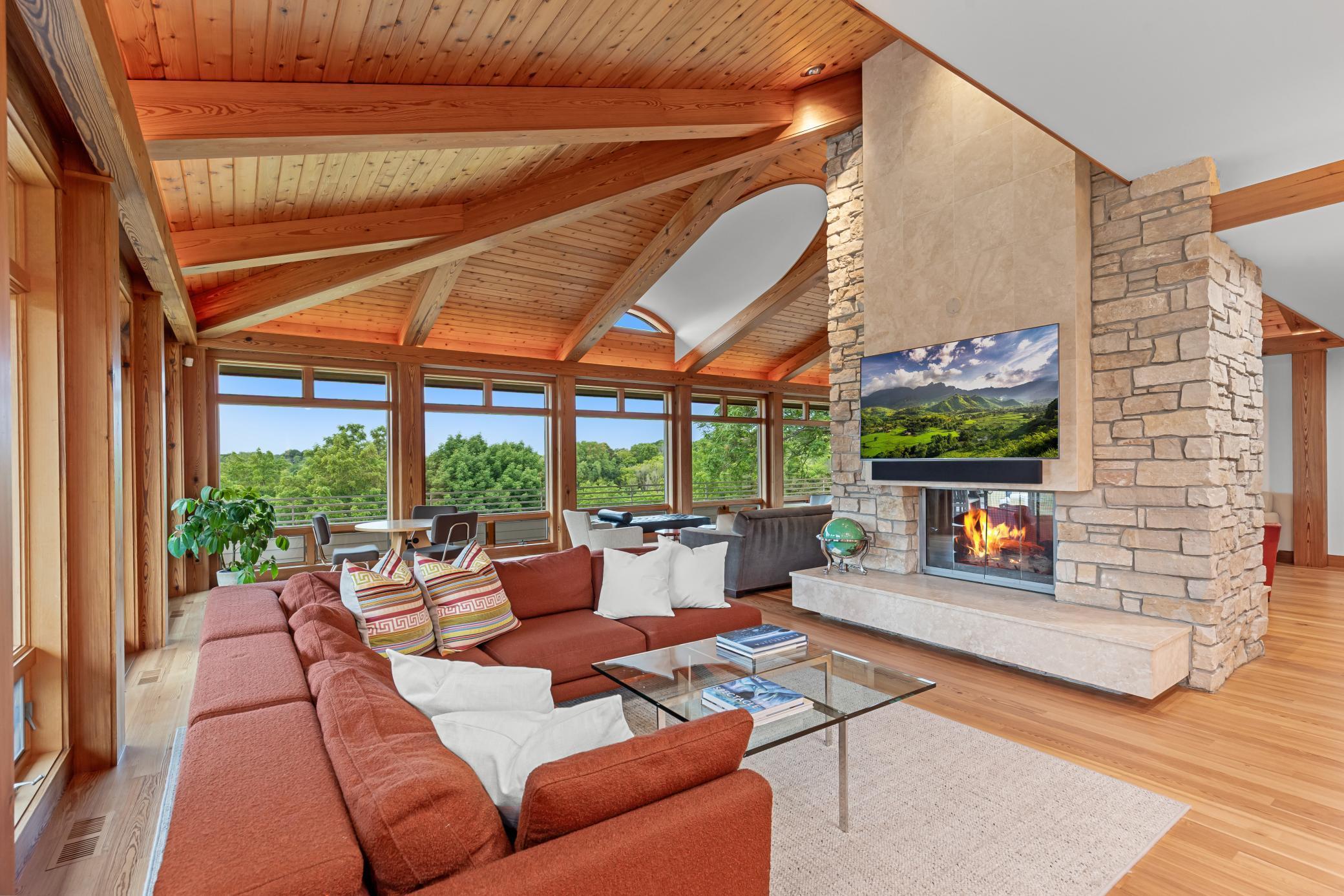 Chilton wall and limestone fireplace adds balance and depth complimented by walls of windows