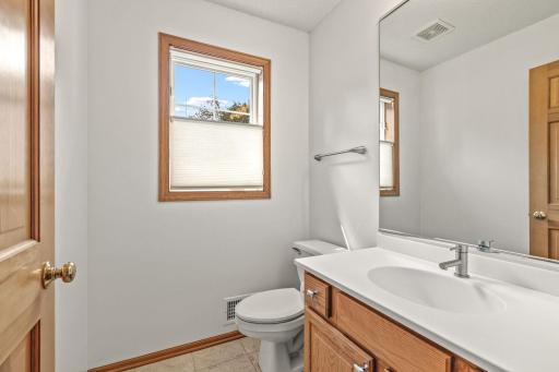 A 1/2 guest bath is discreetly positioned on this homes main level.