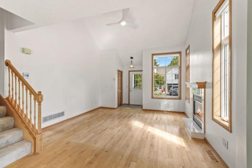 Second view of spacious living room showing its bright, open and vaulted design.
