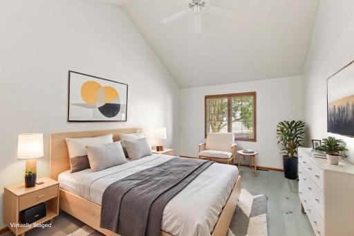 Virtually staged primary suite that lends scale to the space this room offers and ideas for furniture placement.