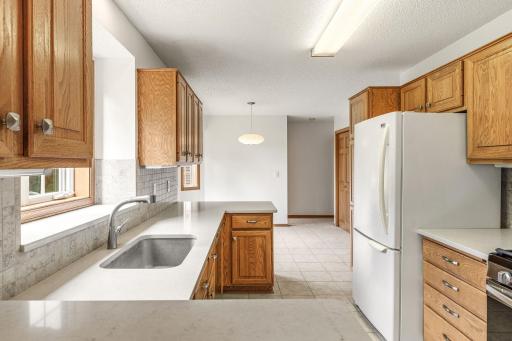 Neutral tile flooring flows throughout the kitchen, informal dining area, laundry closet and 1/2 guest bath.