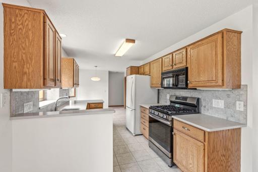 Appliances include a newer stainless undermount sink, garbage disposal, dishwasher, gas range and microwave.