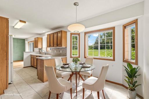 Virtually staged informal dining area that lends scale to the space and ideas for furniture placement.