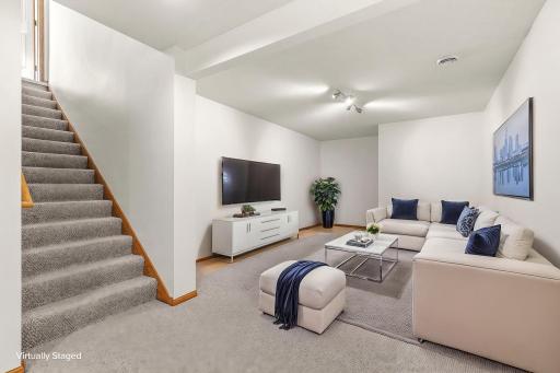 Virtually staged lower-level family room that lends scale to the space this area offers and ideas for furniture placement.