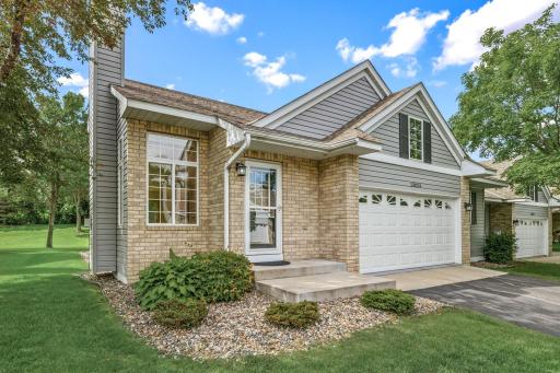 Sparkling clean finished garage with an epoxy floor and interior water spigot, plus a flat driveway and additional guest parking nearby.