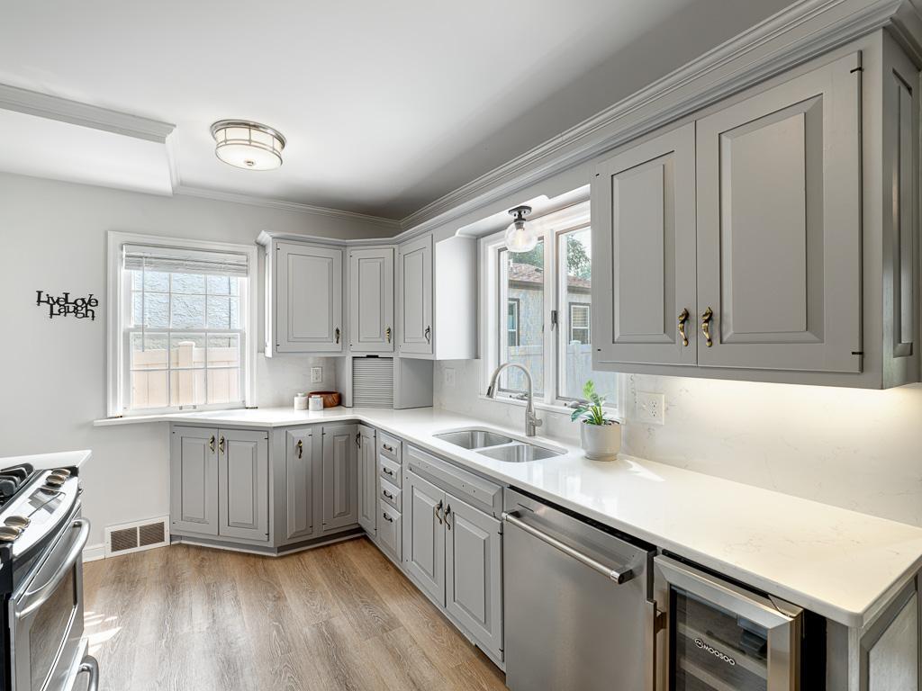 Beautifully appointed kitchen with expansive windows overlooking the backyard, creating a bright and inviting space.