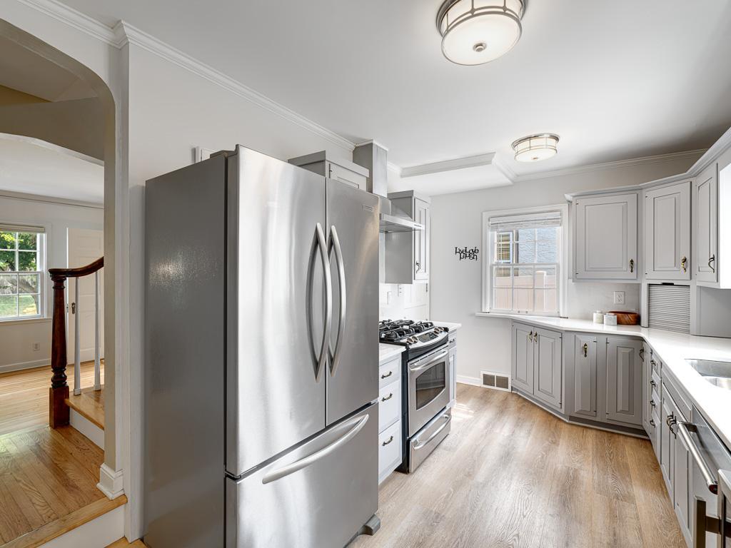 Stainless steel appliances add a modern touch and complement the kitchen’s timeless design.