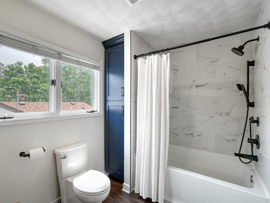 Beautifully appointed full bath, one of two on the upper level, offers comfort and convenience.