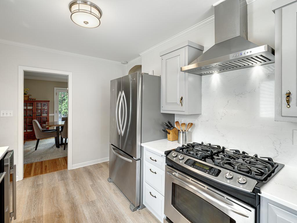 A perfect blend of character and modern updates, this kitchen showcases solid surface countertops and backsplash.