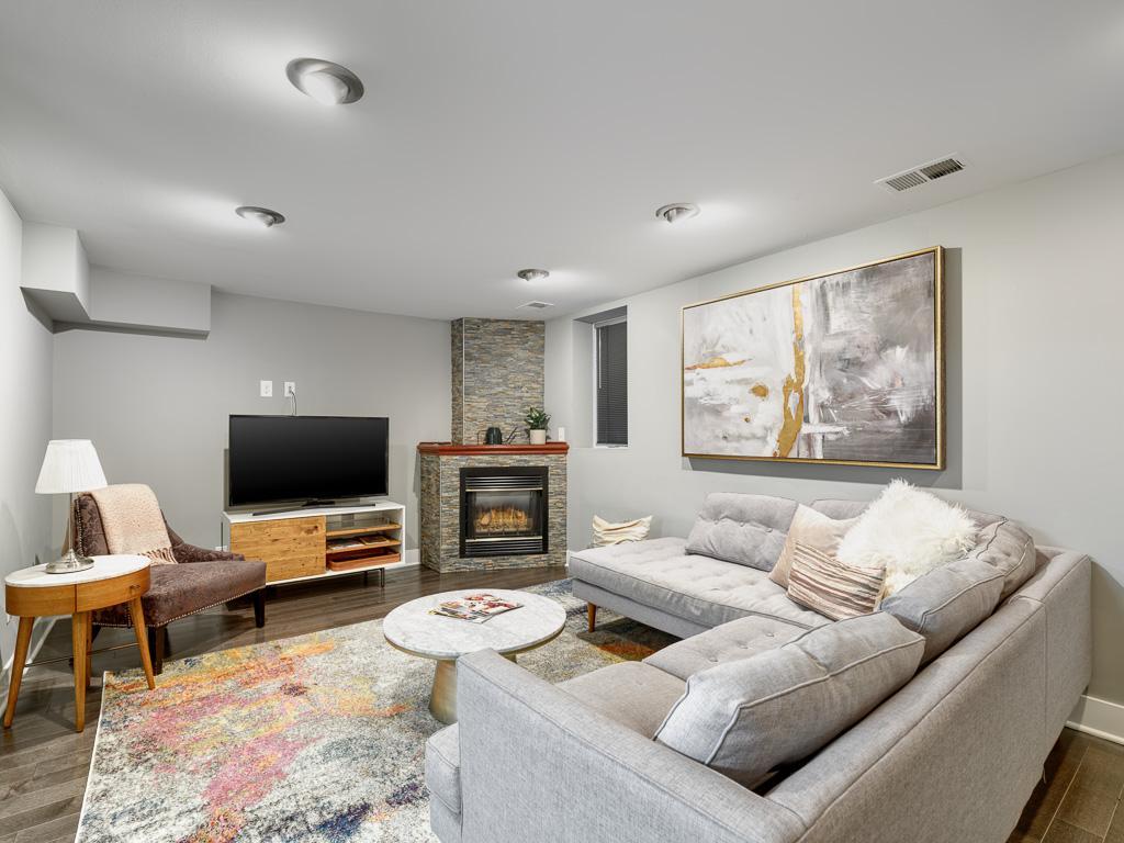 Comfortable lower-level family room with a welcoming gas fireplace, creating the ideal retreat for movie nights and casual entertaining.
