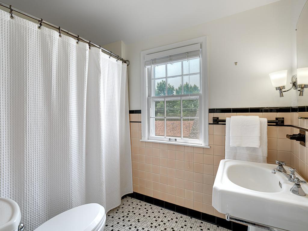 A sought-after feature rarely found in older homes, this second full bath on the upper level adds modern convenience to timeless character.