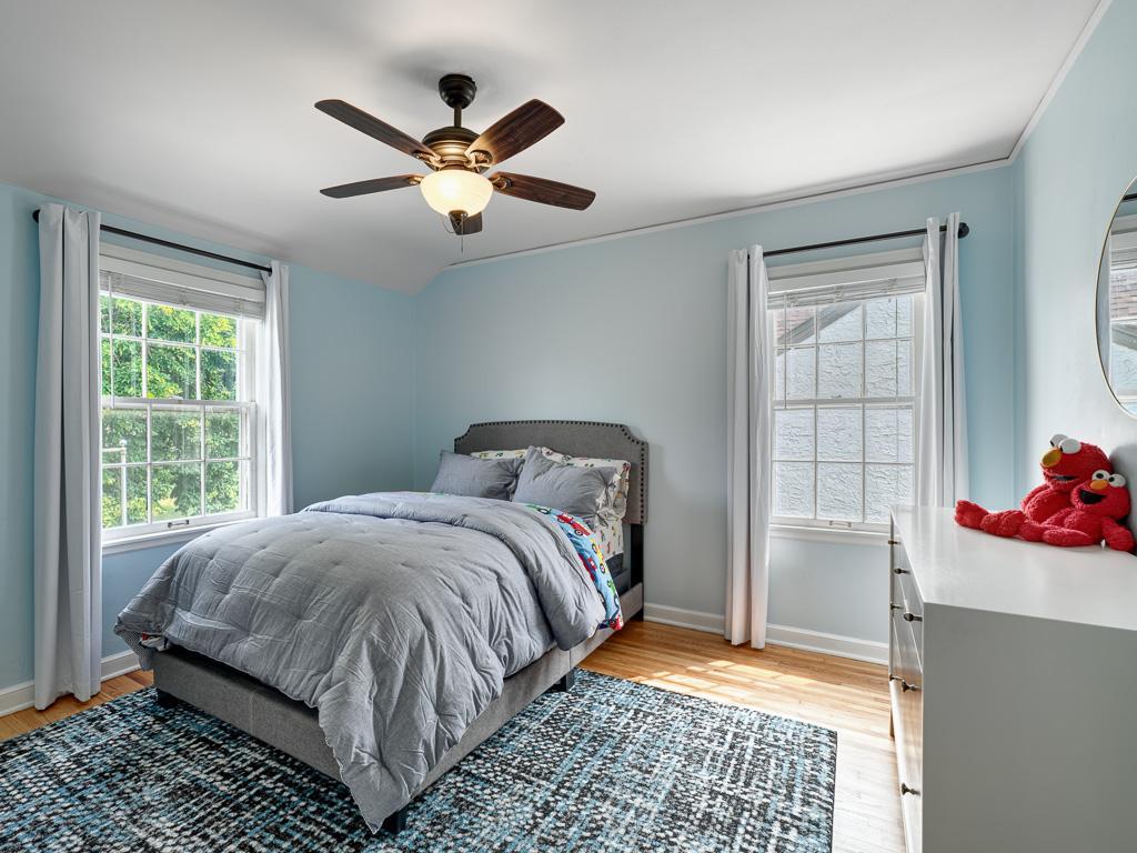 Bright and comfortable third bedroom with serene outdoor views.