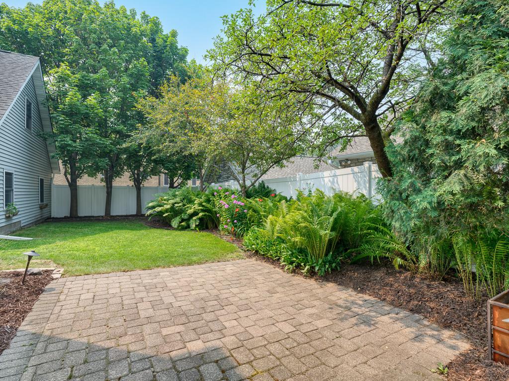 A fully fenced backyard with established gardens offers a private retreat.