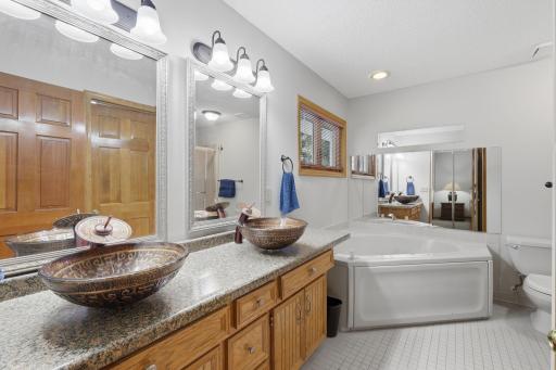 Private primary suite bathroom with soaking tub and separate shower