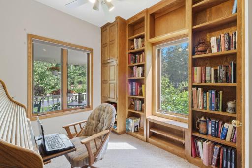 Main floor office with a wall of built in book shelves