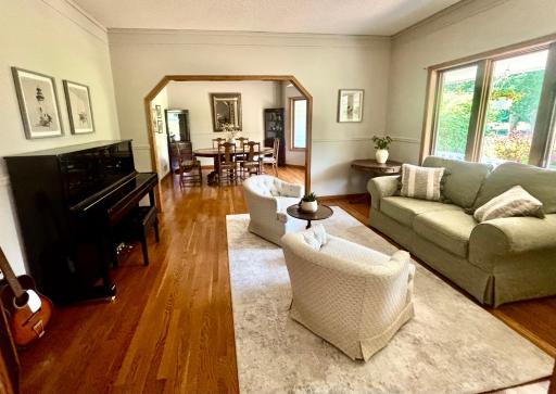 Living room with hardwood floors opens to dining room