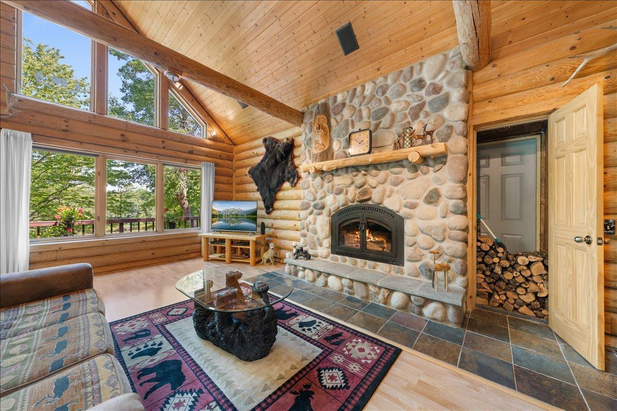 Main floor living room with fireplace and wood storage closet