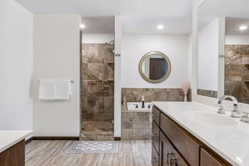 Another view of the jetted tub and tile step-in shower.