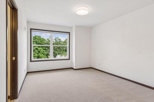 Bedroom three, with brand new carpet, fresh paint, and updated LED lighting.