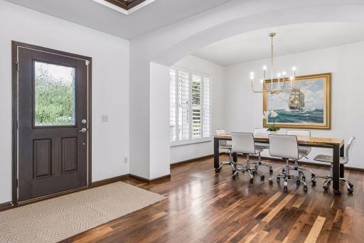 Foyer and formal dining, with oversized windows and adjustable shutters.