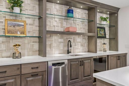 Quartzite counters and custom built-ins with under cabinet lighting.