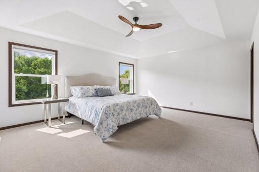 Primary suite with brand new carpet, fresh paint, and updated LED ceiling fan.