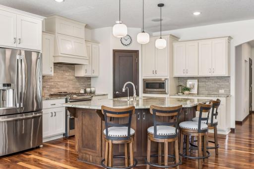 Step-in pantry, tile backsplash, updated pendant lighting.