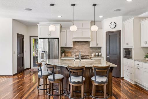Enjoy granite counters and storage on all sides of the oversized kitchen island.