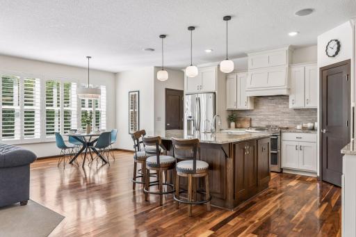 The kitchen showcases a large center island with seating for five.