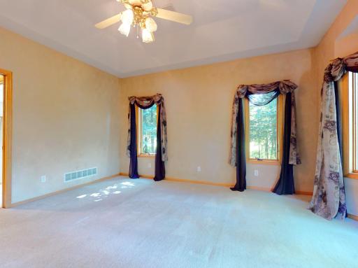 Luxury owners suite w/ ceiling fan / tray ceiling