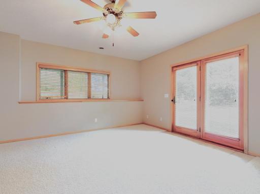 Sitting room w/ ceiling fan / walkout to yard