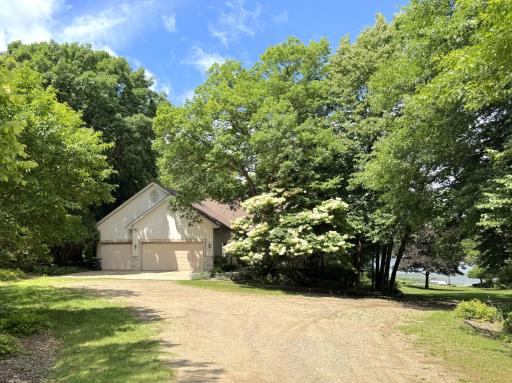 View of front - private w/ variety of trees