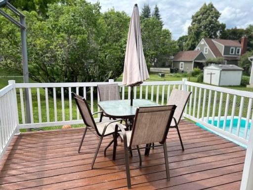 Recently stained deck overlooked fenced backyard.