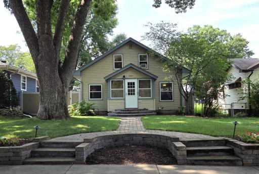 The great street appeal is just the beginning! Look at the gorgeous brickwork welcoming you to the home with the half-circle brick steps to the front porch! Wonderful metal siding & new roof in 2023!