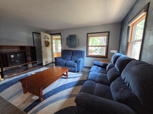 Enter into living room with views into the porch and windows facing south.