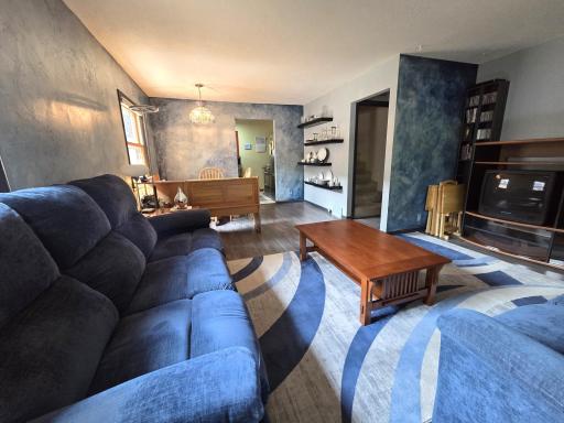 Living room joins dining with floating shelves