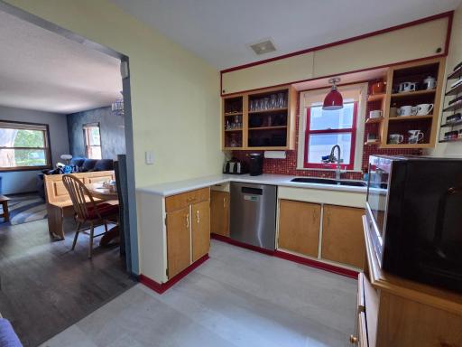 Step into this convenient kitchen! Red backsplash new in 2019, new counter-top, sink & faucet in 2016.