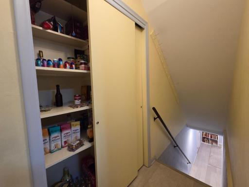 And, around the corner, there is a large pantry, and steps to the lower level.