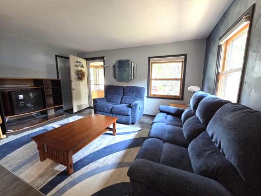 Enter into living room with views into the porch and windows facing south. 20260818_134557.jpg