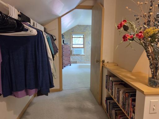 When you reach the top of the stairs, to the right is this walk-thru closet w/laundry chute & entrance into primary bedroom