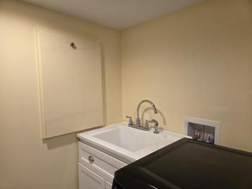 Next to the sink- pull that handle on the right, and it drops down to a folding area!
